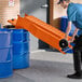 A man using an orange Fryclone oil shuttle.