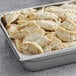 A metal tray filled with Chef One vegetable dumplings.