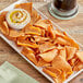 A plate of Issa's Restaurant Style Pita Chips with dip.