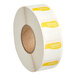 A roll of white labels with yellow Tuesday labels.