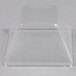 A clear plastic dome lid on a white surface.