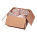 A cardboard box filled with brown packages of Kronos Foods Traditional Beef and Lamb Small Gyros.