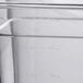 A close up of a clear Choice 1/6 size polycarbonate food pan on a counter.