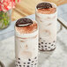 Two glasses of milk tea with a cookie on top made with Bossen Cookies and Cream powder.
