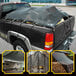 A black Core 7' x 18' heavy-duty mesh tarp covering a truck bed.