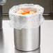 A silver stainless steel container with food in it.