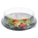 A bowl of salad with Fineline clear plastic lid on top.