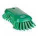 A green Vikan scrub brush with stiff bristles.