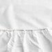 A close up of a white Oxford Super Deluxe Queen Size fitted sheet with red stitching.