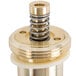 A close-up of a T&S brass and gold metering barrel assembly with a spring inside.