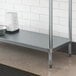 A galvanized metal shelf with a bowl and bowl on it.