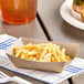 A Southern Champion paper food tray with macaroni and cheese.