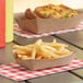 A Southern Champion paper food tray with French fries and a hot dog.