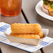 A Southern Champion paper food tray with fried food on a table.