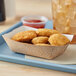 A Southern Champion paper food tray with fried chicken nuggets and a drink.