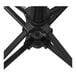 A black metal California Umbrella Company umbrella stand on a table.