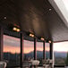A Boltic black electric infrared heater on an outdoor patio table.