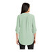 A woman wearing a Misty Sage Port Authority short sleeve blouse.