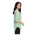 A woman wearing a Port Authority misty sage green short sleeve blouse.