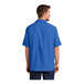 A man wearing a Port Authority short sleeve blue shirt.