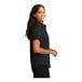 A woman wearing a black and light stone Port Authority dress shirt.