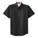 A black Port Authority short sleeve dress shirt with a light stone collar on a hanger.