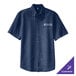 A Port & Company men's ink blue denim button-up shirt on a table.