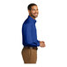 A man wearing a Port Authority blue poplin dress shirt.