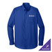 A medium Port Authority long sleeve blue dress shirt on a counter with a logo.