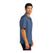 A close-up of a Port Authority blue short sleeve camp shirt with a button down collar.