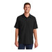 A man wearing a Port Authority short sleeve black shirt.