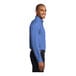 A man wearing an ultramarine blue Port Authority long sleeve dress shirt.
