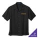 A black Port Authority short sleeve camp shirt with a logo on the pocket.
