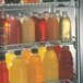 A Metro qwikSLOT wire shelf full of drinks.