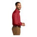 A man wearing a Port Authority rich red long sleeve poplin dress shirt.