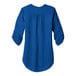 A blue Port Authority short sleeve blouse with a ruffle on the back.