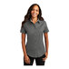 A woman wearing a Port Authority steel gray and light stone short sleeve button down dress shirt.