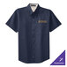 A navy Port Authority short sleeve dress shirt with a logo on the chest.