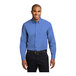 A man wearing an ultramarine blue Port Authority long sleeve dress shirt.
