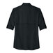A black Port Authority casual shirt with rolled up short sleeves.