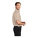 A close-up of a Port Authority stone short sleeve dress shirt on a man.