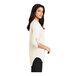A woman wearing an ivory short sleeve chiffon blouse.