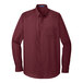 A Port Authority burgundy long sleeve poplin shirt.