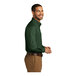 A man wearing a Port Authority deep forest green long sleeve poplin dress shirt.