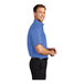 A man wearing a Port Authority ultramarine blue short sleeve dress shirt.