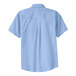 A close-up of a Port Authority light blue and light stone short sleeve dress shirt.