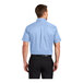 A man wearing a Port Authority light blue short sleeve dress shirt.
