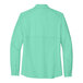A back view of a bright seafoam green short sleeve Port Authority shirt.