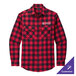 A red and black plaid Port Authority flannel shirt on a table.