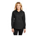 A woman wearing a Port Authority black and light stone long sleeve dress shirt.